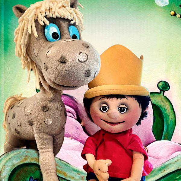 Eine Figur des kleinen Prinzen steht neben einer Pferdefigur.